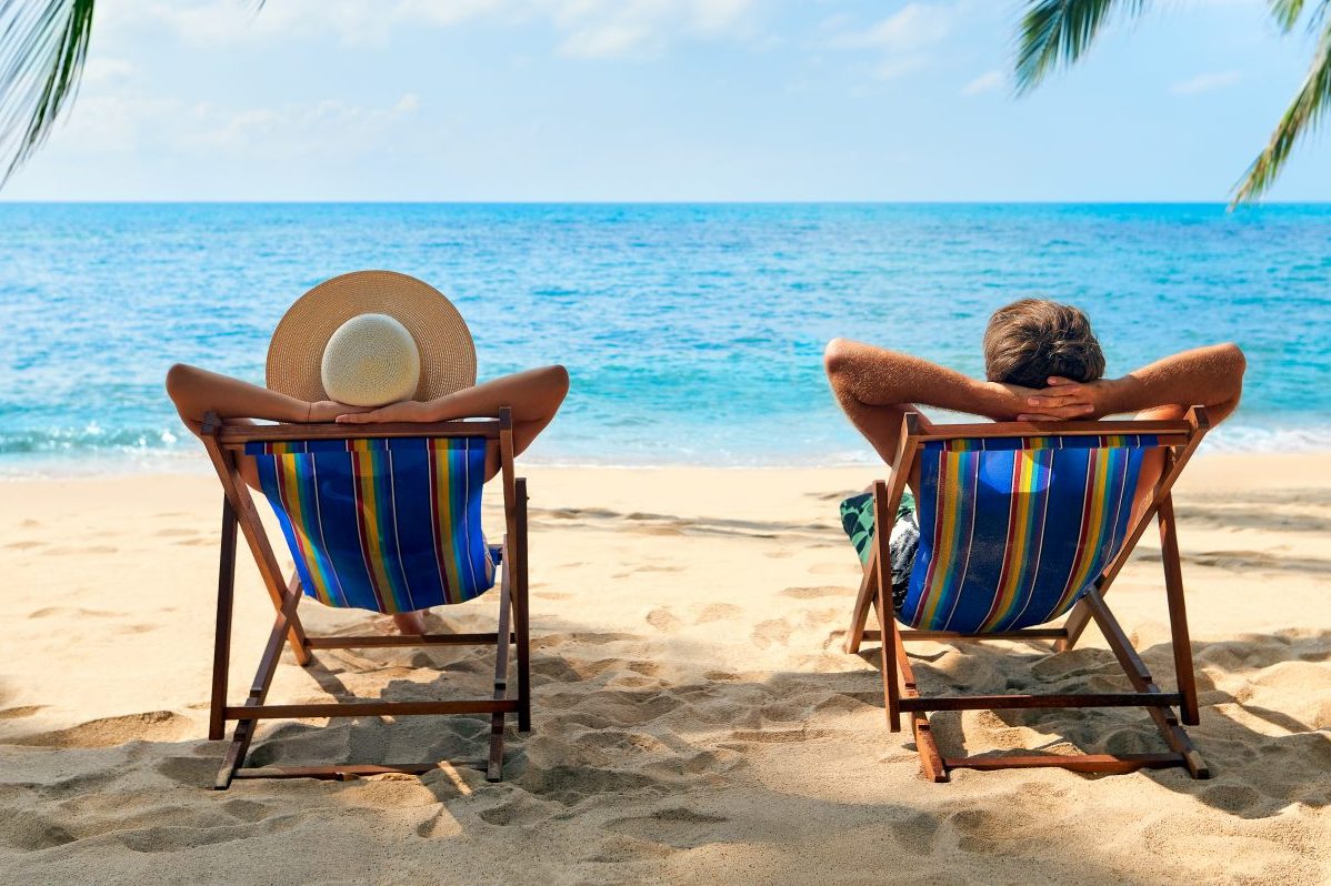 Couple relax on the beach enjoy beautiful sea on the tropical island.